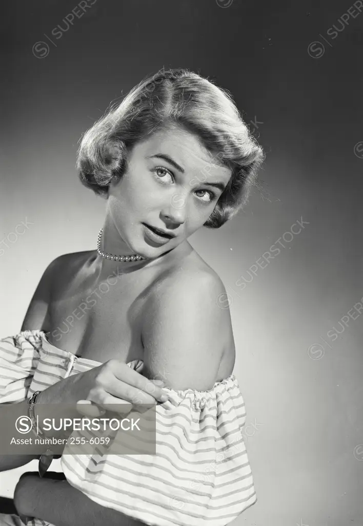 Vintage Photograph. Woman in striped blouse looking over shoulder
