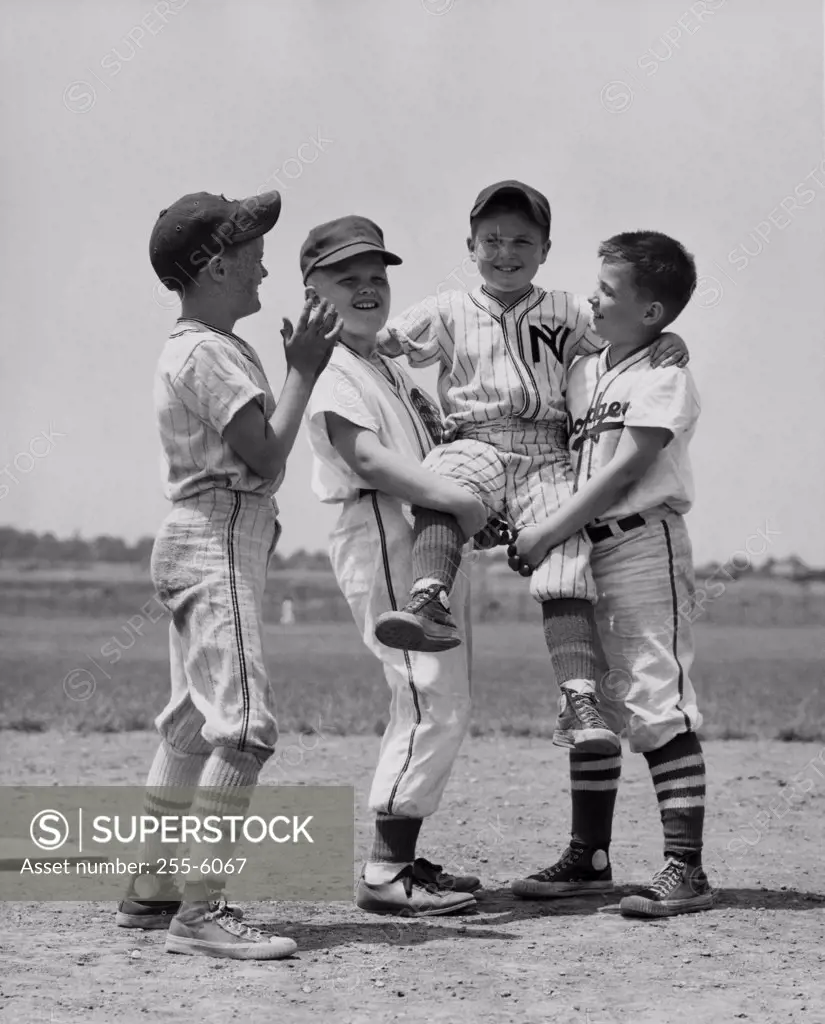 Boys of youth league baseball team celebrating their victory