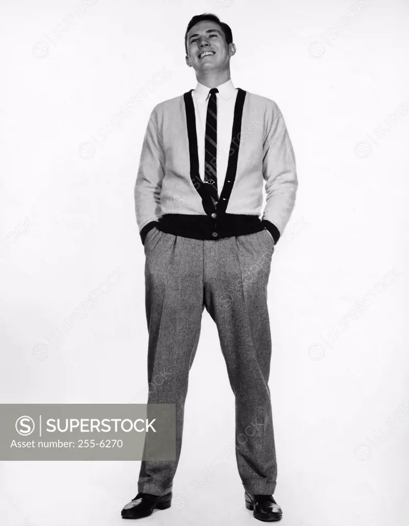 Young man standing with hands in pockets