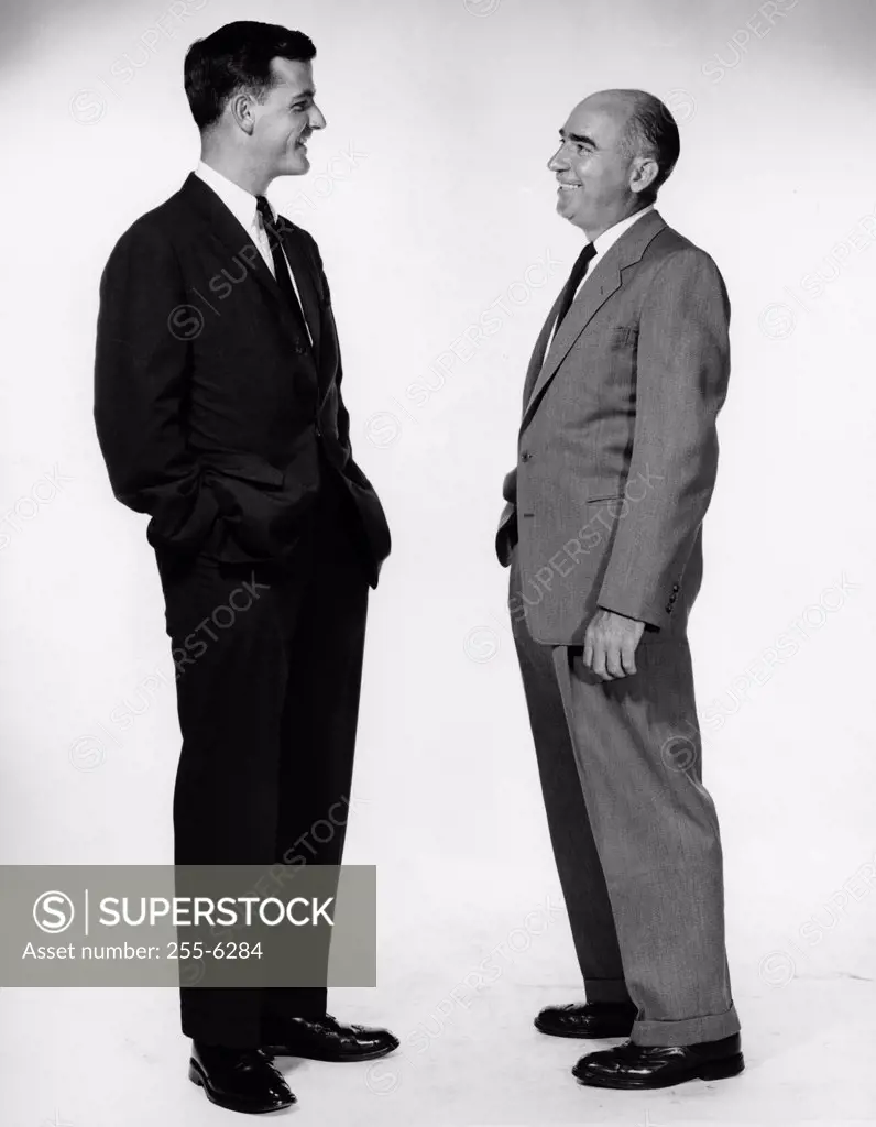 Side profile of two businessmen talking to each other