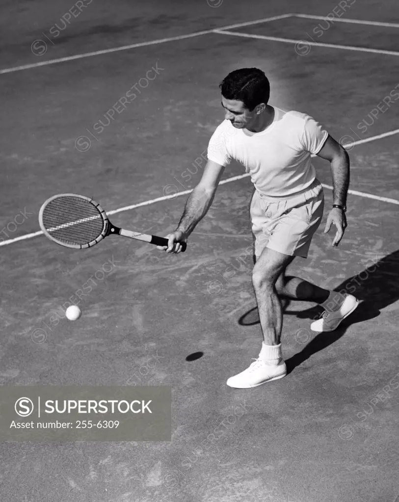 High angle view of a young man playing tennis on a tennis court