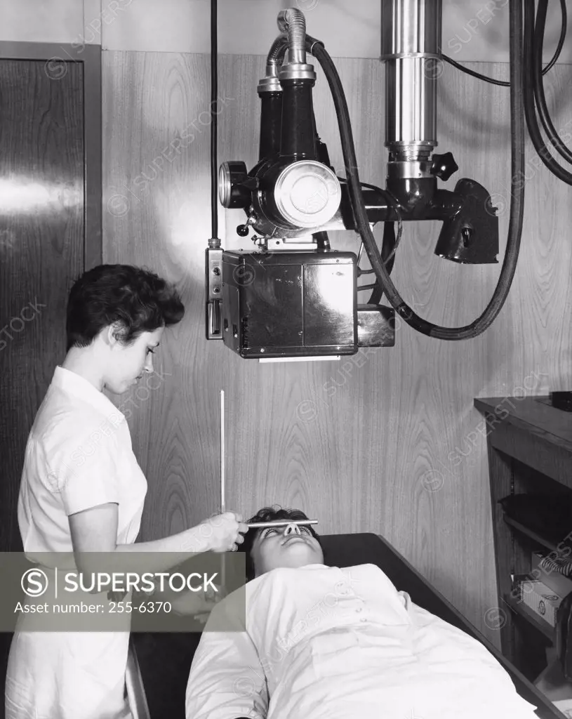 Female radiologist taking an x-ray of a patient