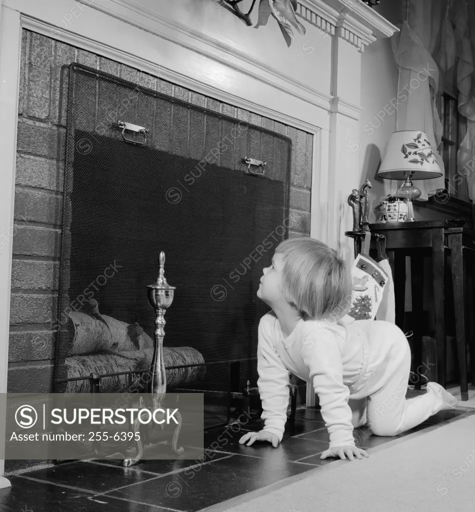 Side profile of a girl peeping into a fireplace