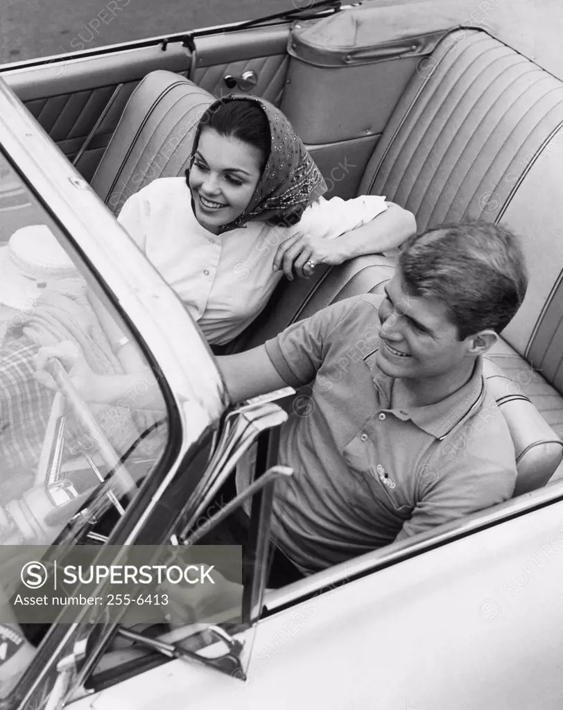 High angle view of a young couple sitting in a convertible car
