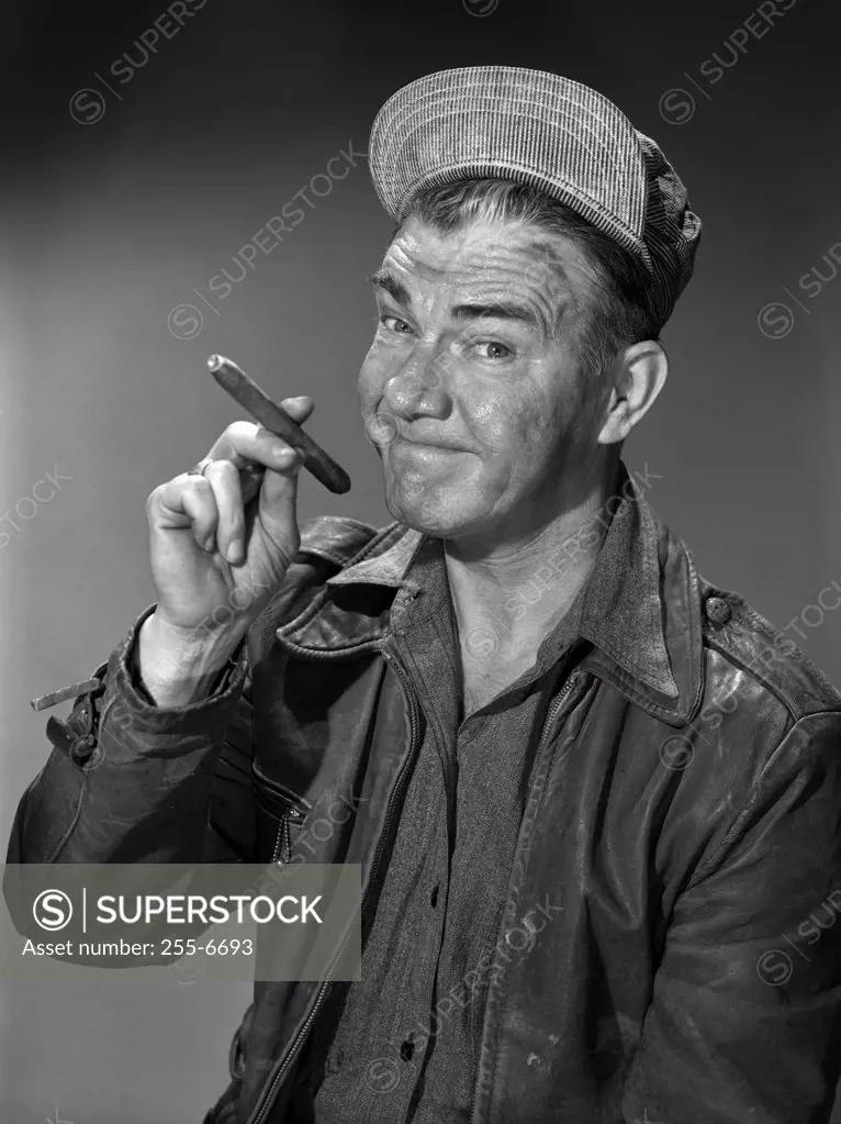 Studio portrait of man smoking cigar
