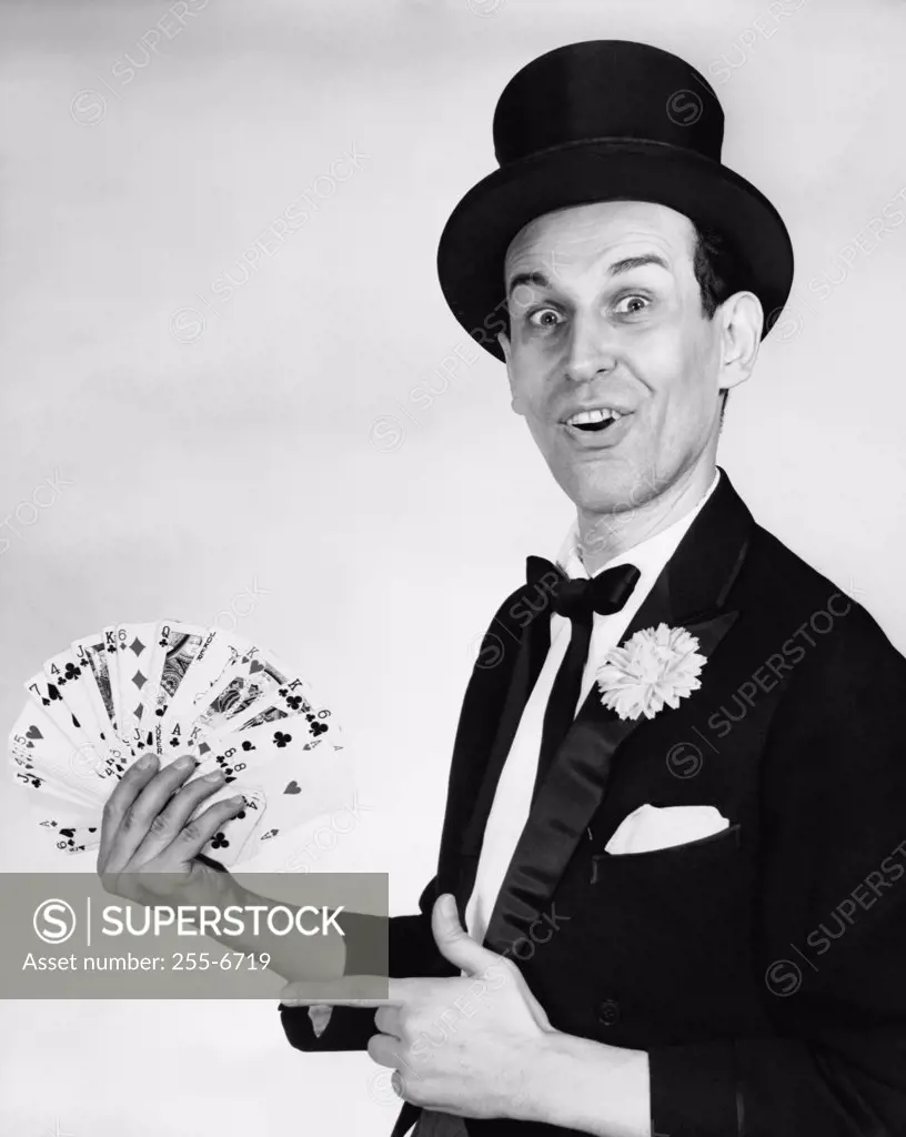 Portrait of a magician performing card tricks