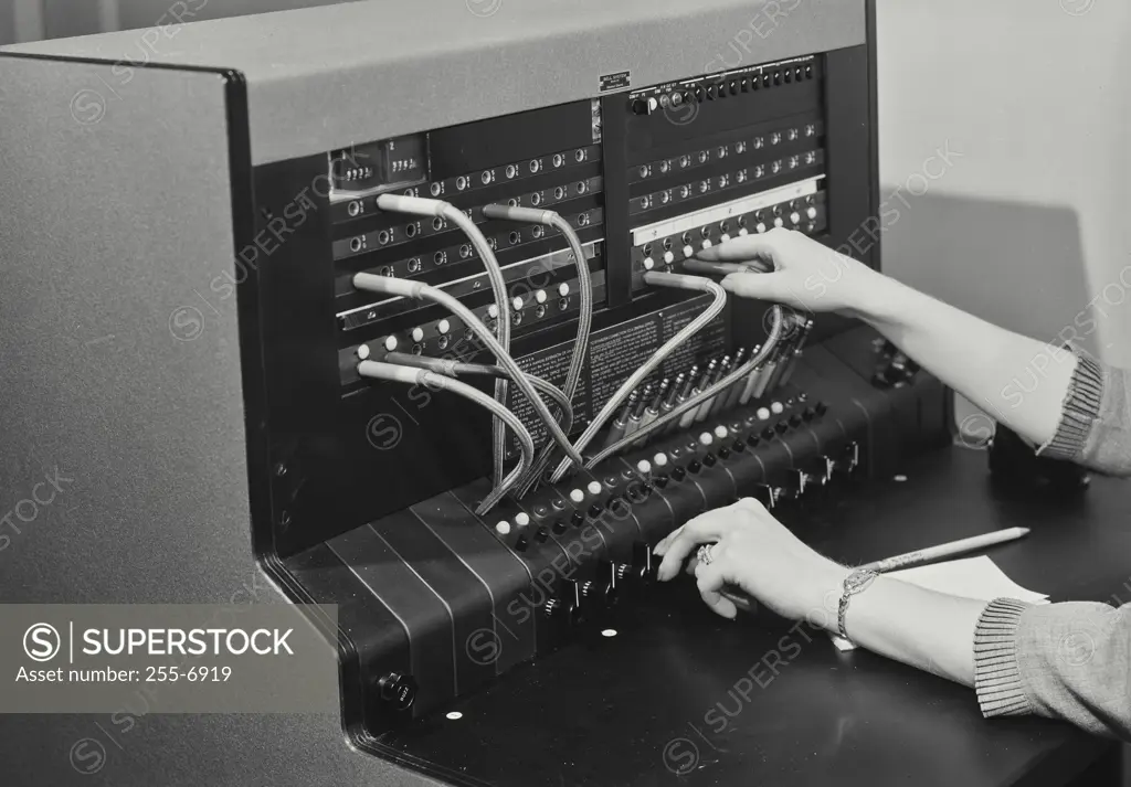 Vintage Photograph. Female hands operating telephone switchboard