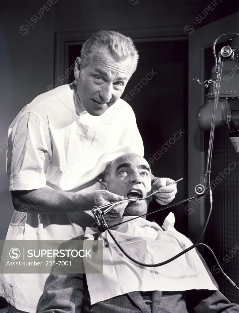 Nervous male patient getting treatment from a male dentist