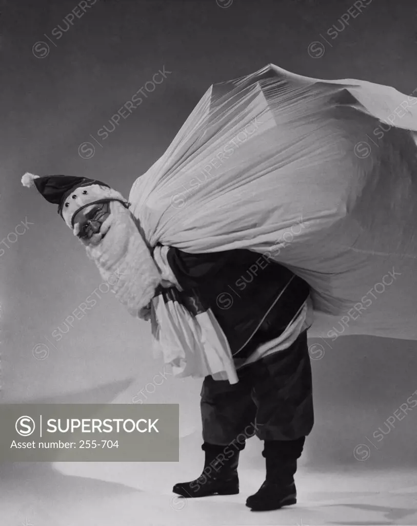 Portrait of Santa Claus carrying sack of gifts on his back