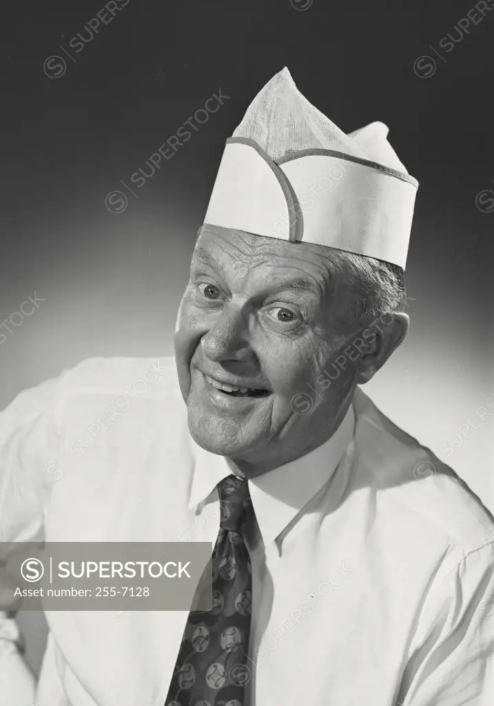 Man dressed in fry cook uniform smiling at camera