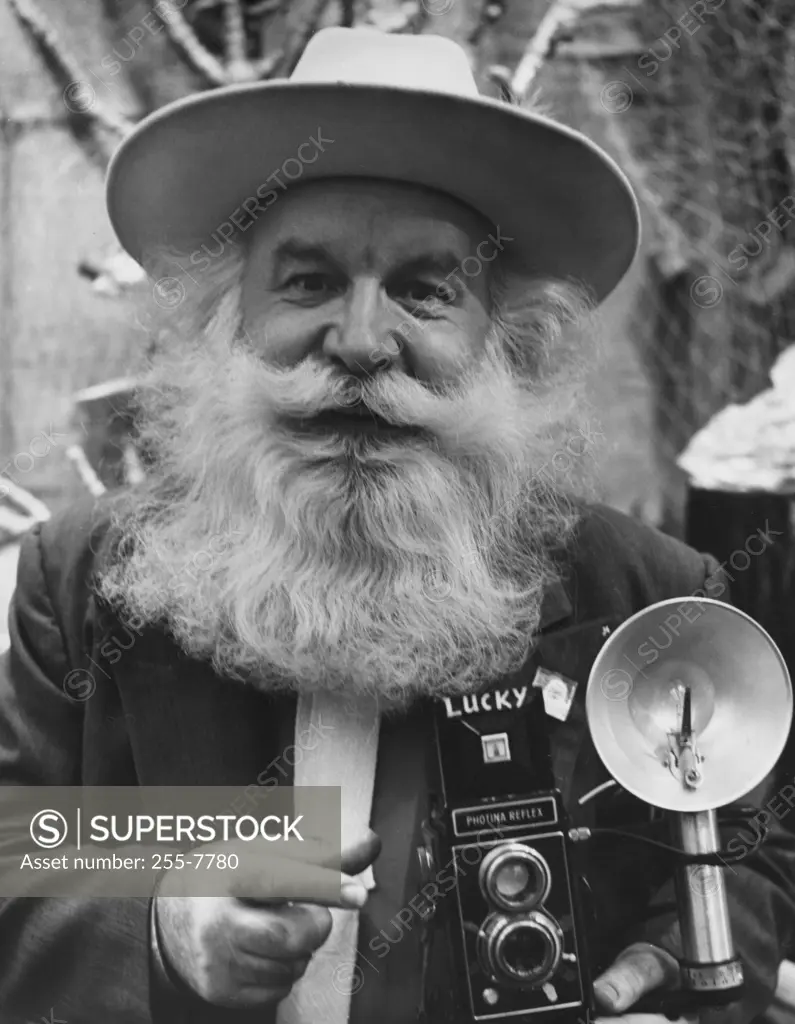 Portrait of a senior man holding a camera