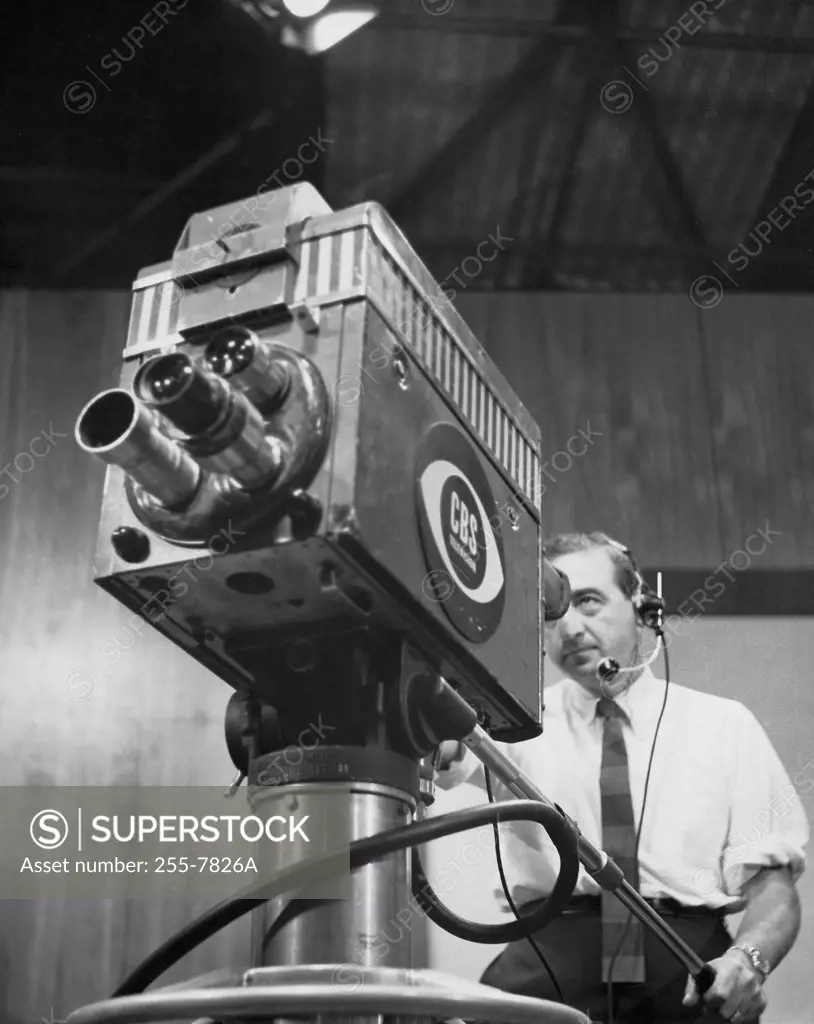 Low angle view of a cameraman operating a television camera