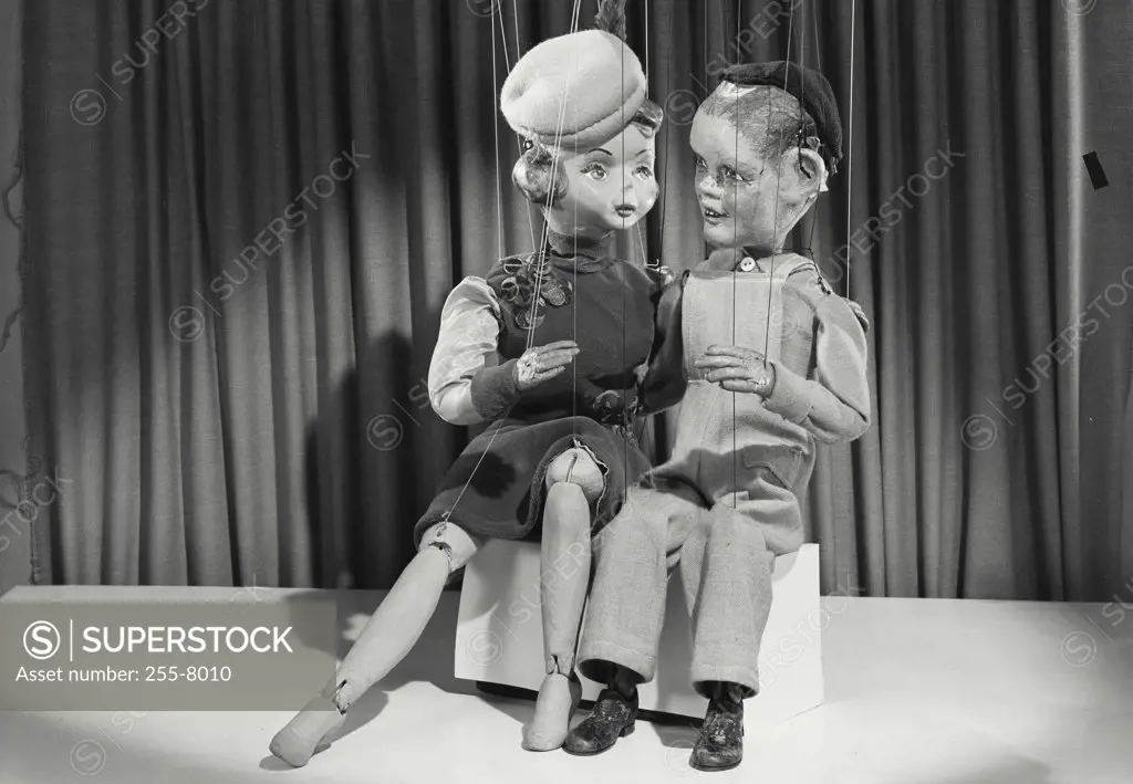 Vintage photograph. Male and female puppets sitting having a conversation