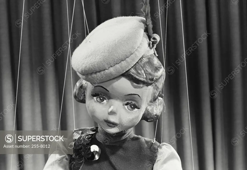 Vintage photograph. Closeup of female puppet wearing hat