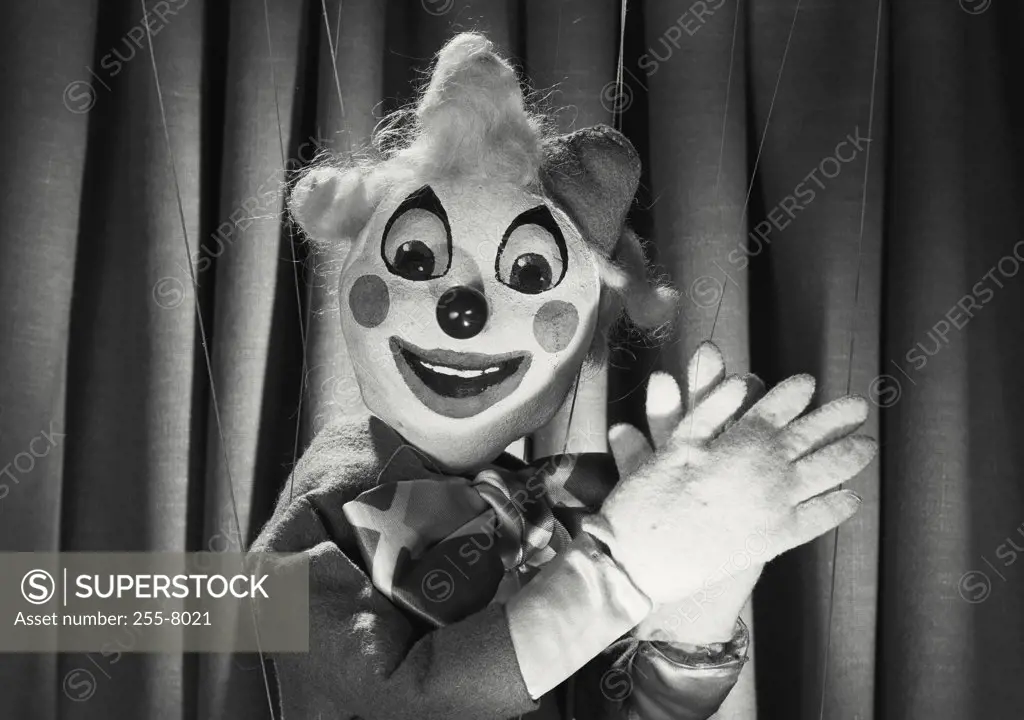 Vintage photograph. Clown marionette with hands up