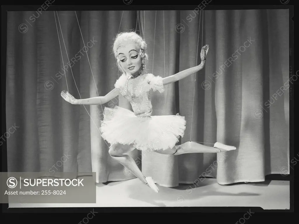 Vintage photograph. Close-up of a female marionette dancing