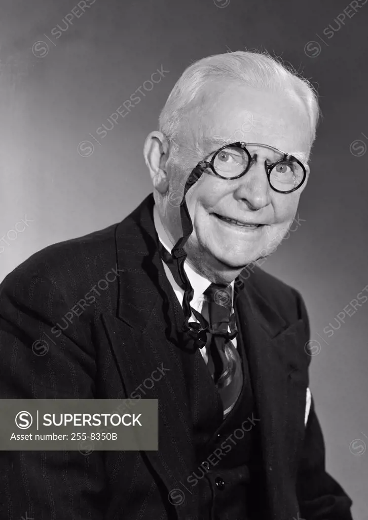 Portrait of smiling senior man wearing pince bez