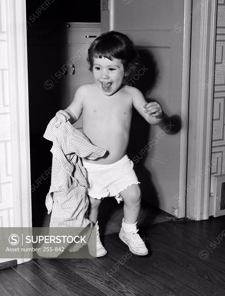 Boy holding shirt in home