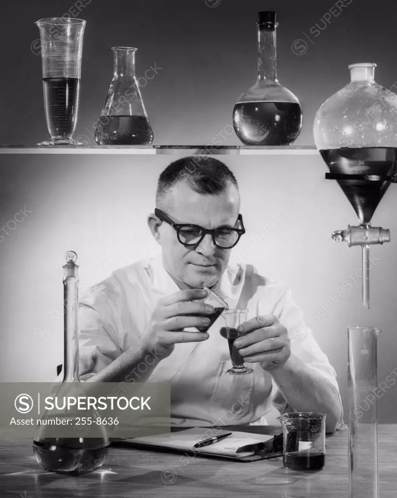 Scientist pouring chemicals in a laboratory