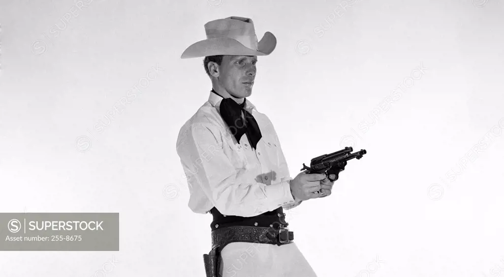 Side profile of a cowboy holding two pistols