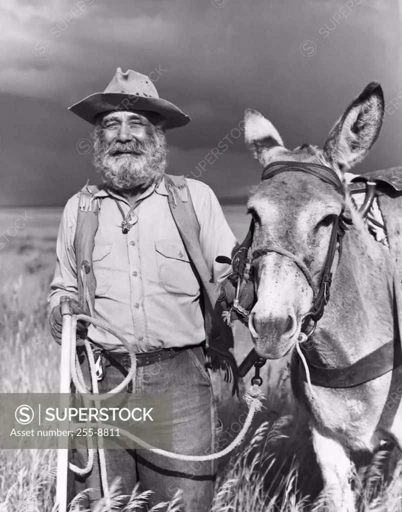 Portrait of a miner with his donkey