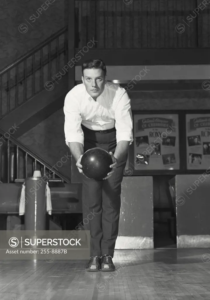 Vintage photograph. Young adult man about to bowl