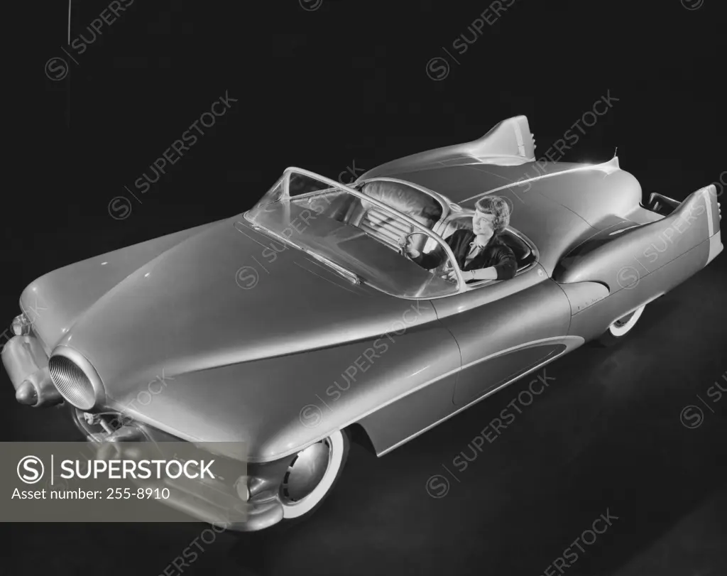 High angle view of a woman sitting in a coupe, 1950s Buick LeSabre prototype