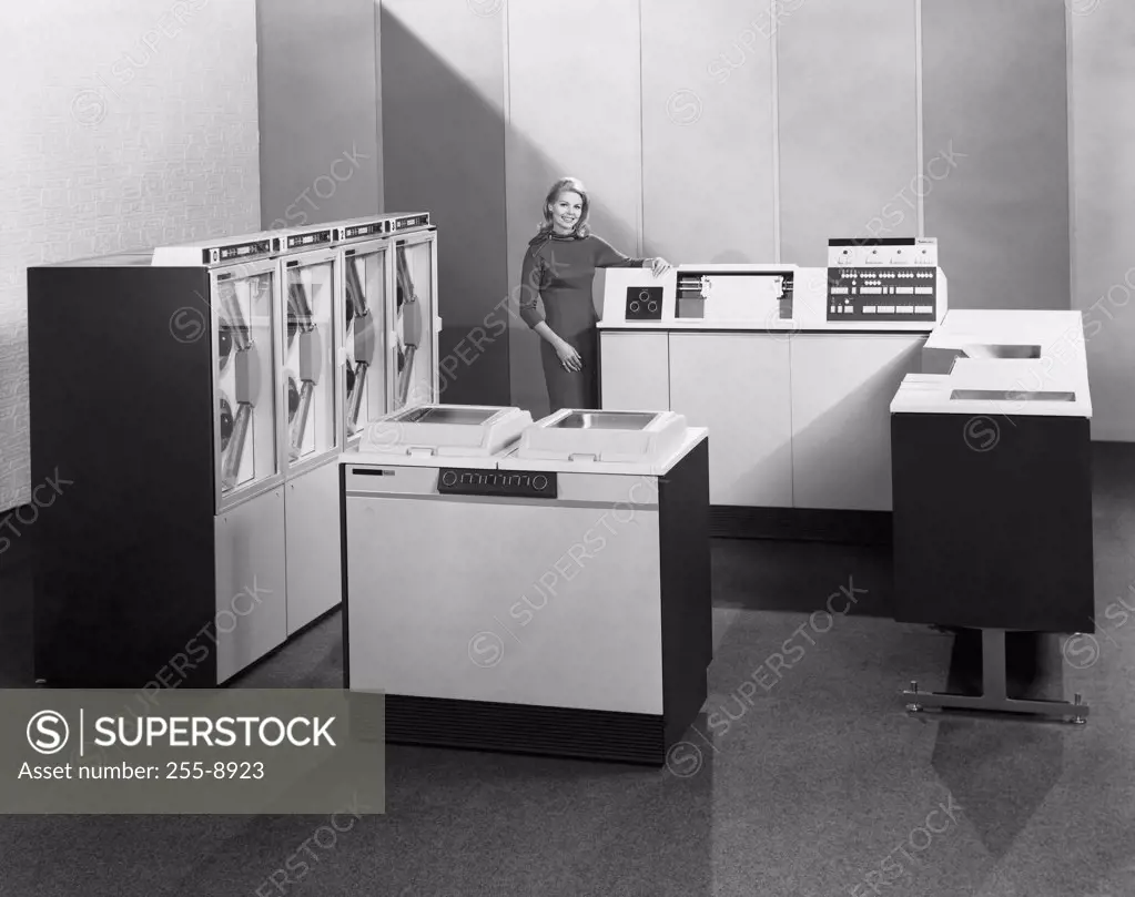 Businesswoman standing near a data processing system, 1968