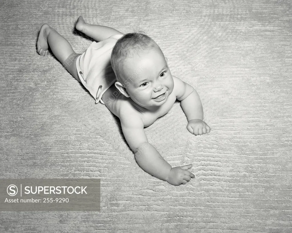 Vintage photograph. High angle view of a baby smiling