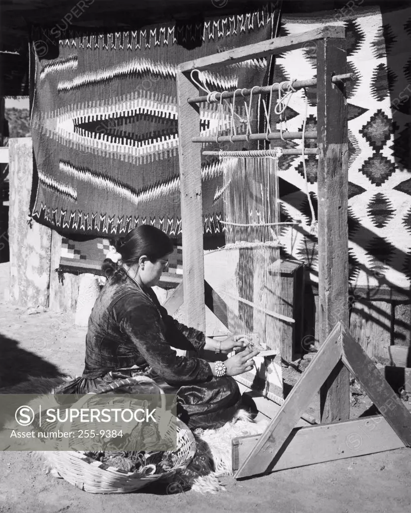 Navajo woman working on a loom