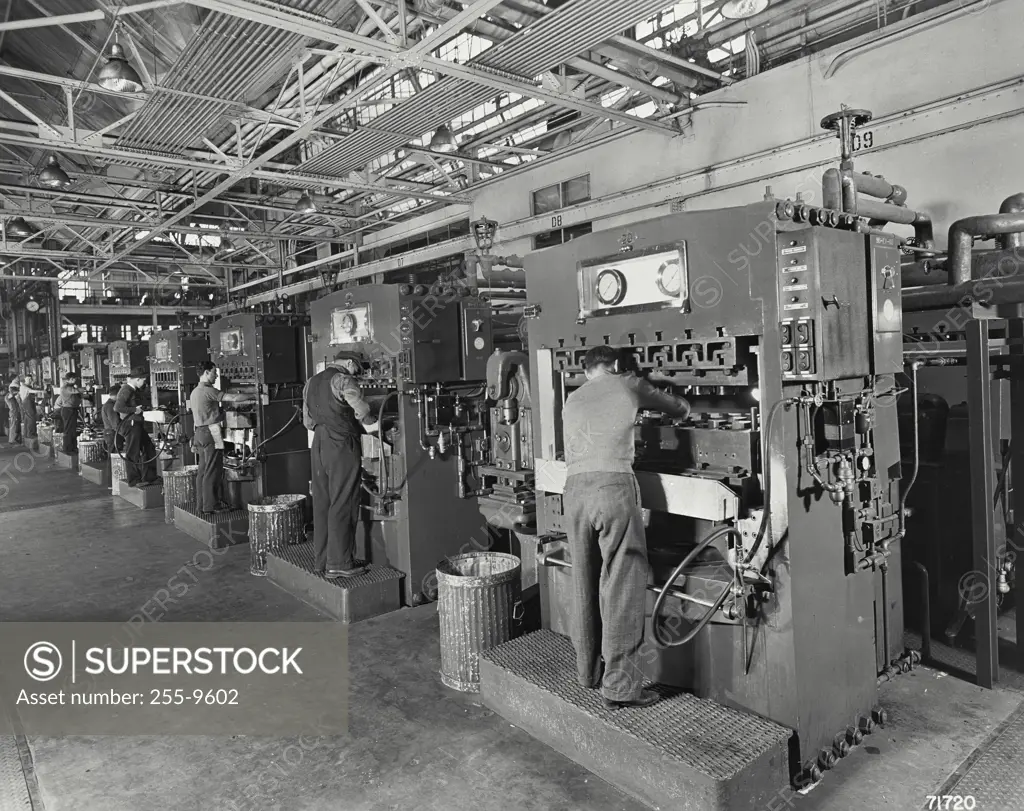 Vintage Photograph. Plastic injection molding presses. The plastic used here is obtained from the soybean.