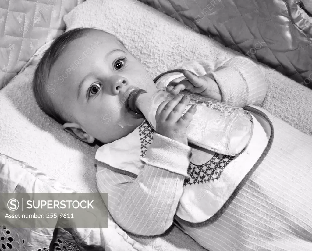 Baby drinking milk from baby bottle