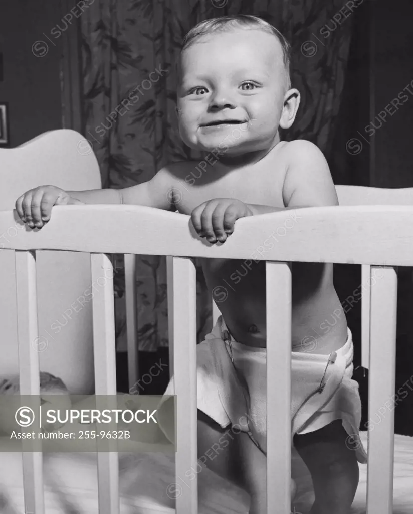 Baby standing in a crib