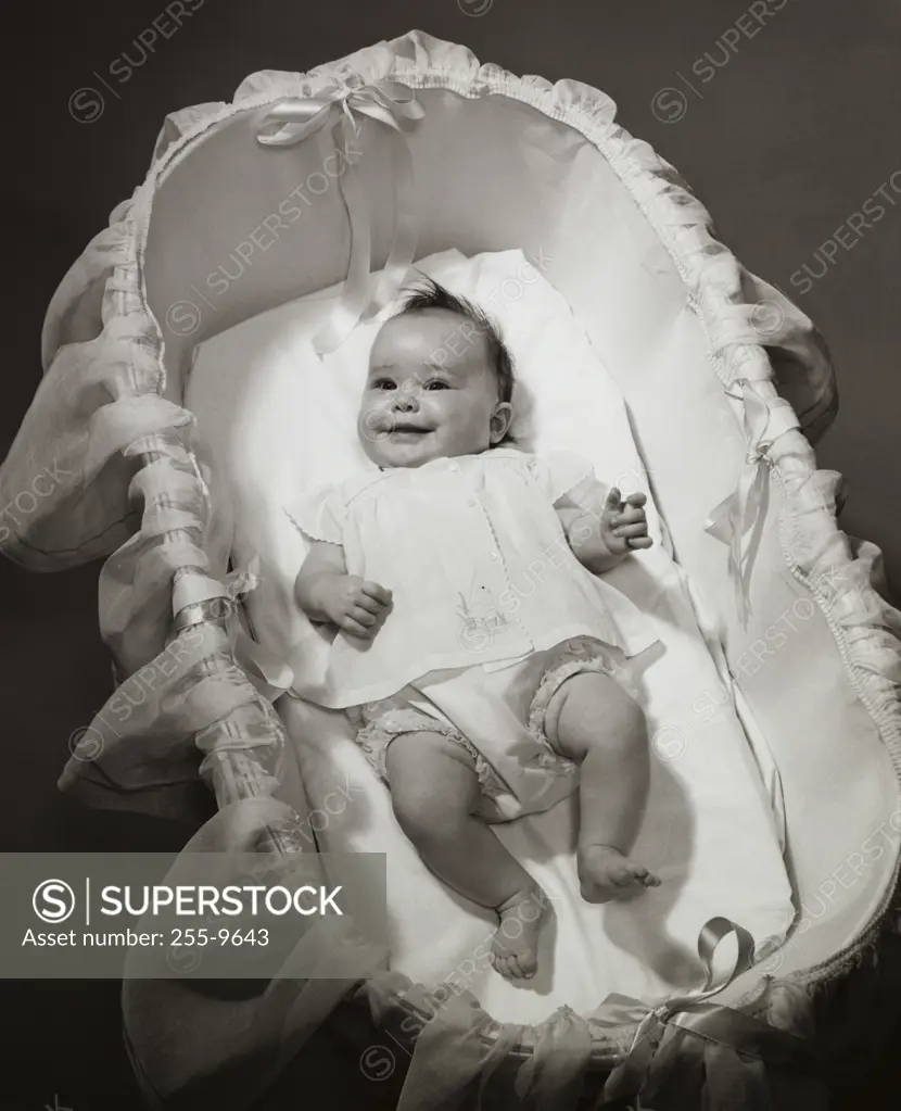 High angle view of a baby girl lying in a bassinet