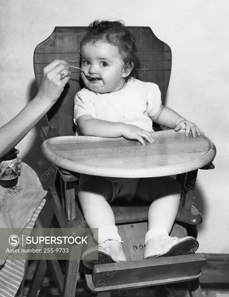 Baby feeding in high chair