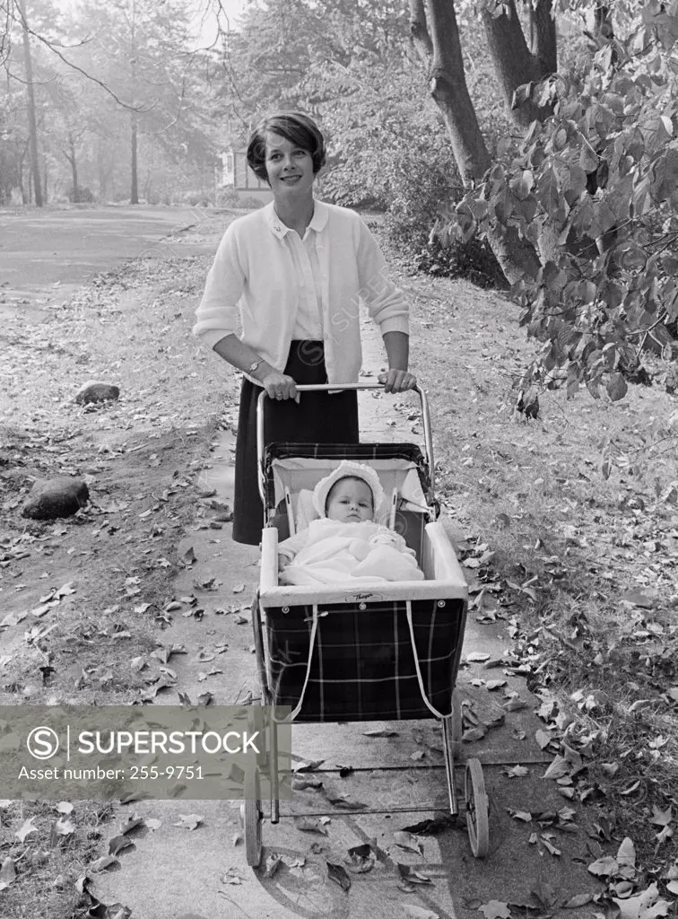 Mother walking with baby in baby carriage