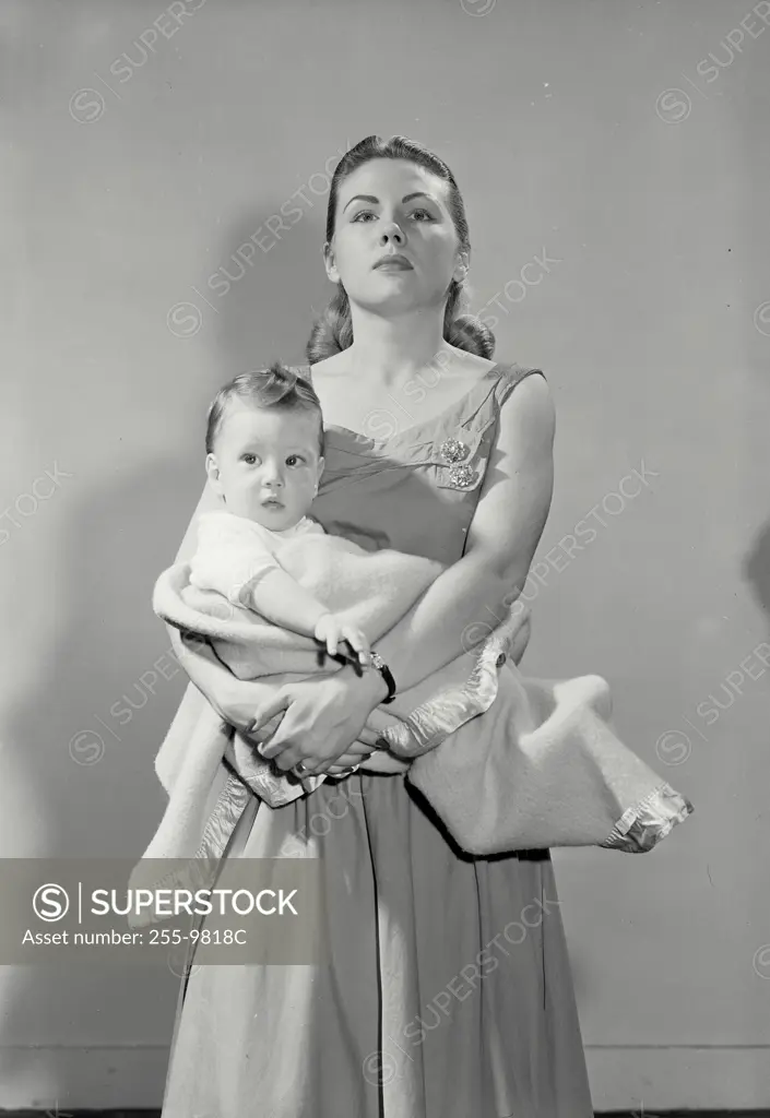 Vintage Photograph. Mother cradling her son swaddled in baby blanket