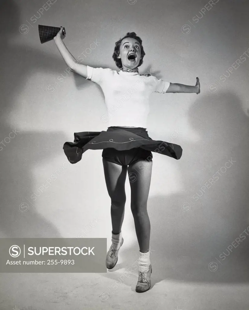 Teenage girl shouting with her arms outstretched