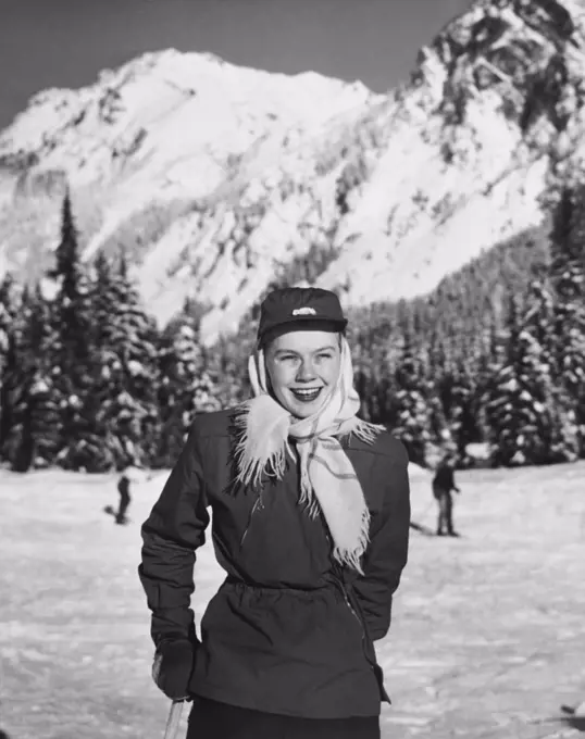 Young woman holding a ski pole and smiling, Cascade Range, Washington, USA
