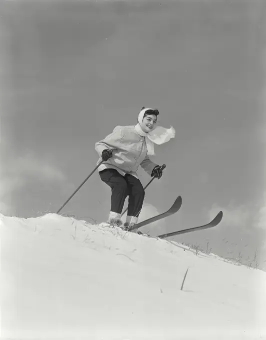 Vintage Photograph. Woman on skis at top of hill.