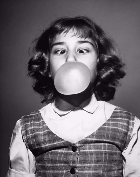 Close-up of a girl blowing a bubble