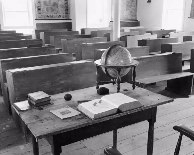 Globe and books in an empty classroom