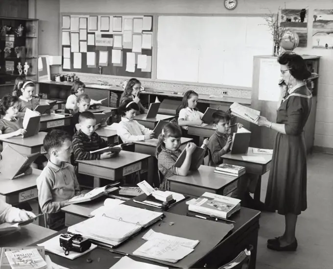 School children in a classroom with a female teacher