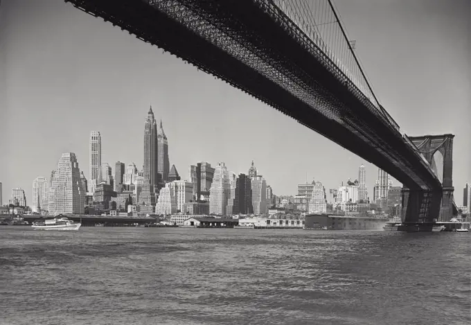 Vintage photograph. new york skyline as seen from under brooklyn bridge