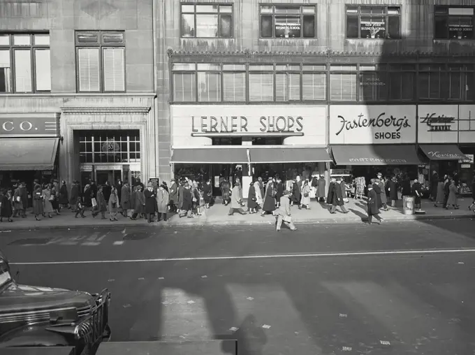 Vintage photograph. crowd walking in front of Lerner shoes in new York city