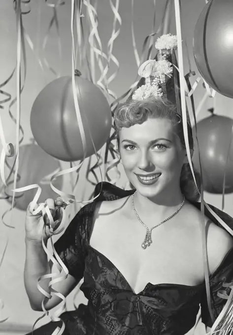 Vintage photograph. Woman in party hat in party scene