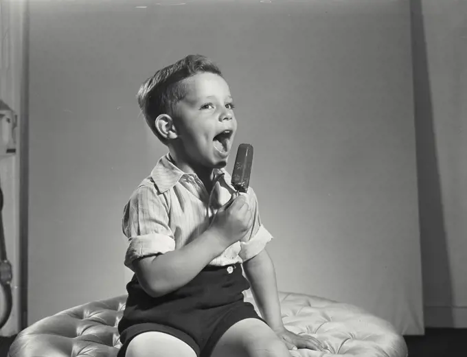 Vintage photograph. Little boy with ice cream pop.