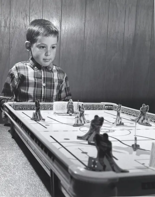 Boy standing near an ice hockey table