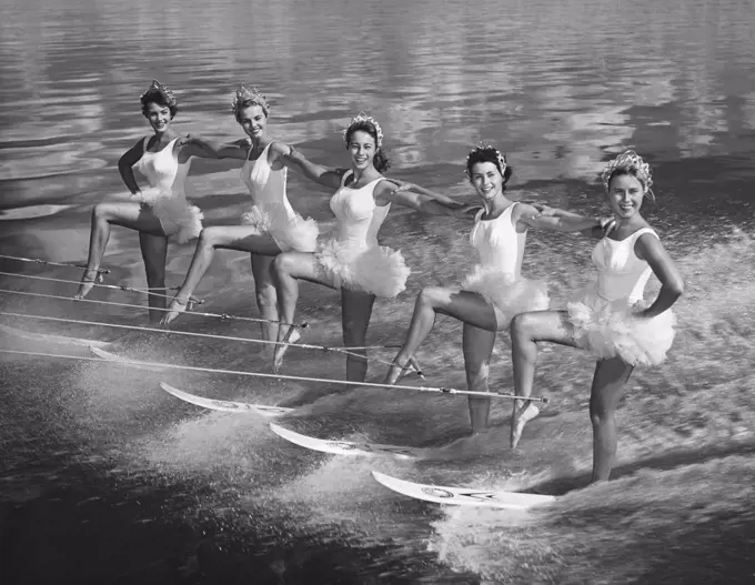 Five young women waterskiing