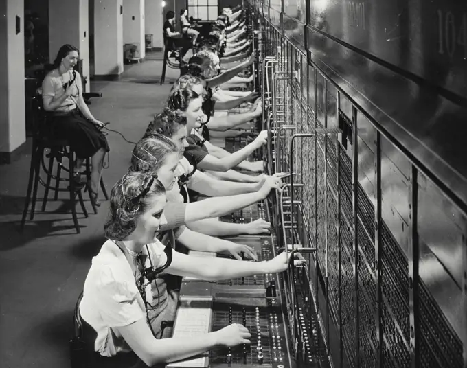 Vintage Photograph. A battery of long distance switch boards in the long lines building at 32 Ave. of the Americas, New York City